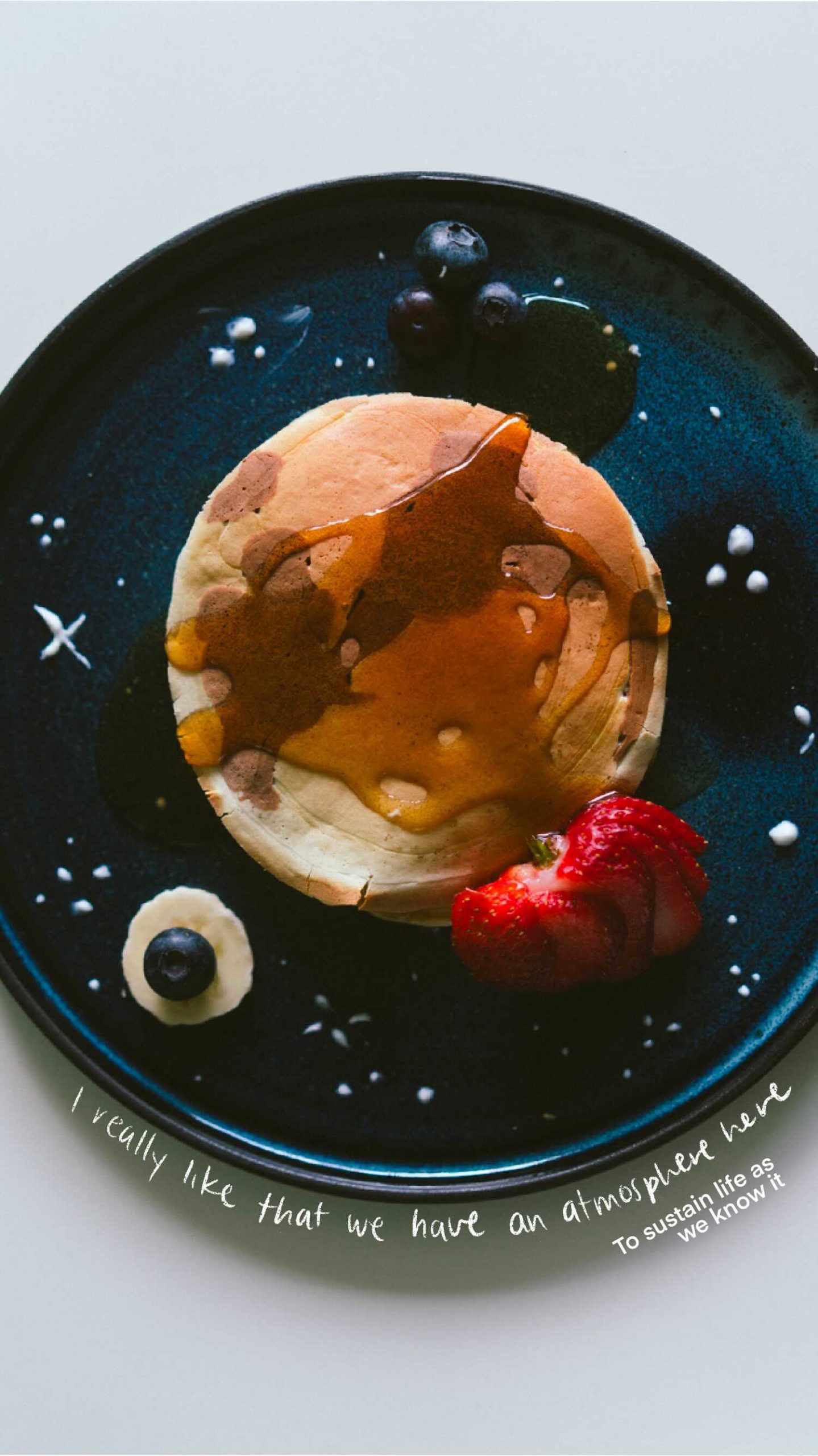 Pancakes (representing earth) on plate with strawberries quote - I really like that we have an atmosphere here