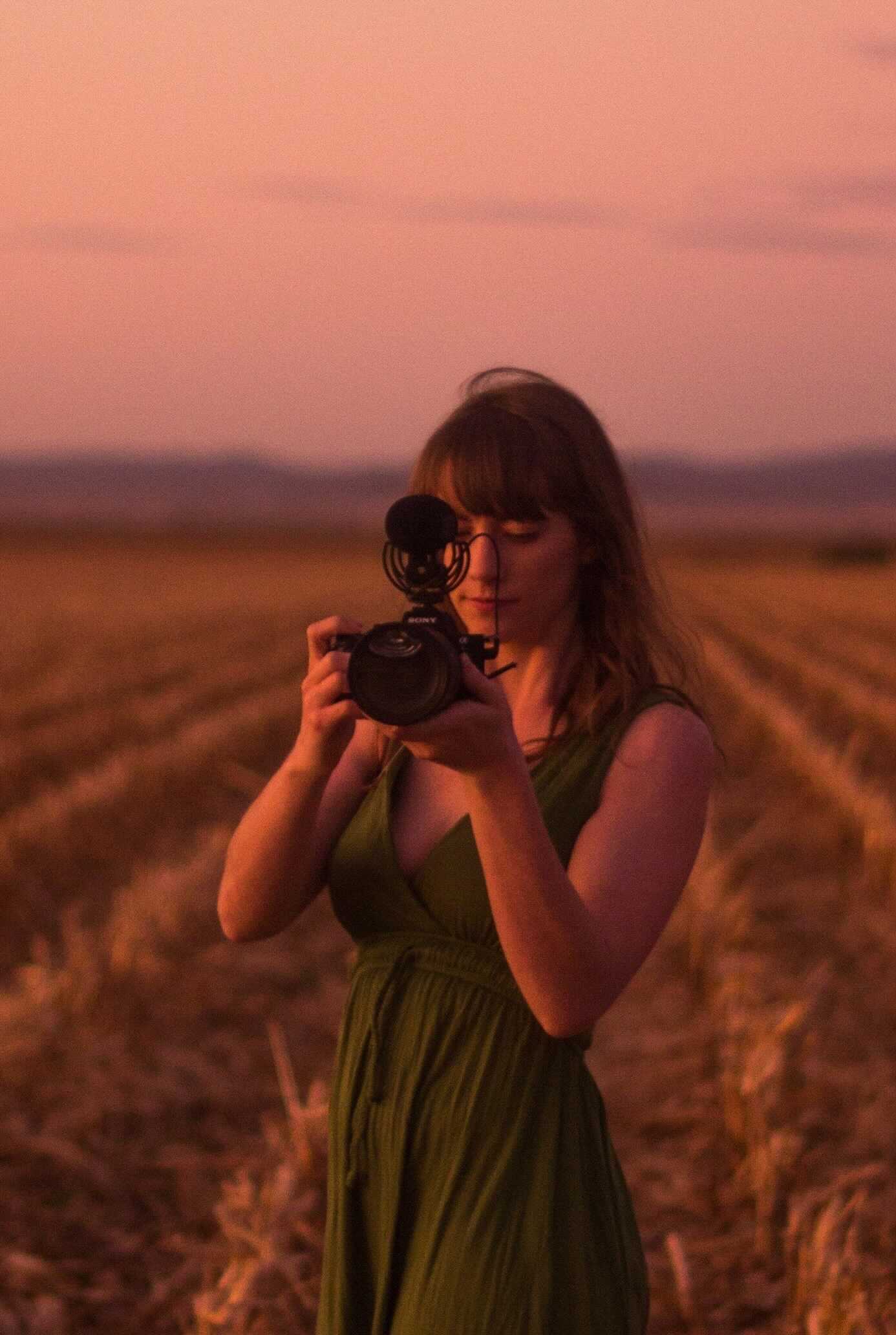 Stephie Reimer Picture of Stephie Reimer in a a field holding a camera