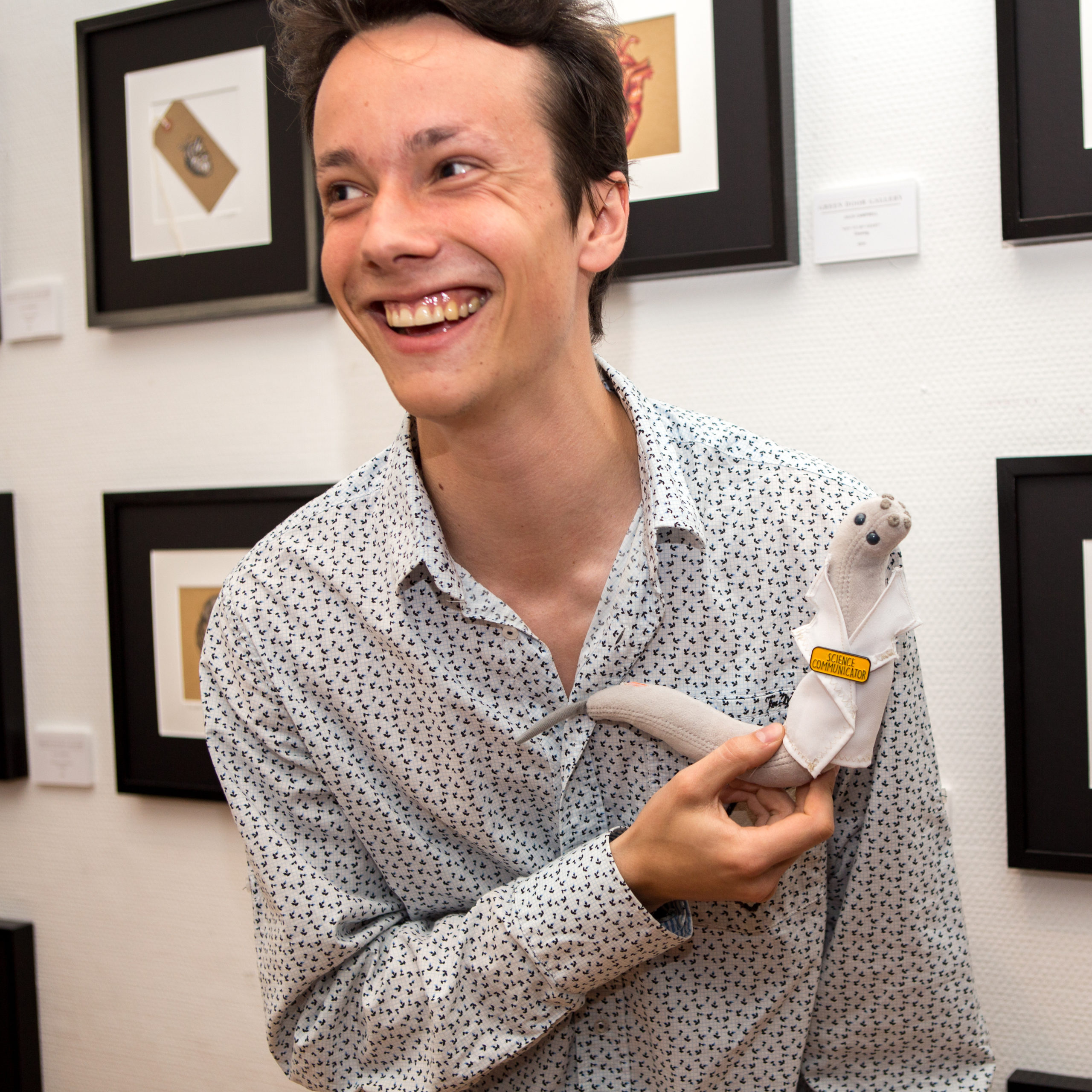 Picture of Lucas Mergan with Wormy, the lab's mascot.